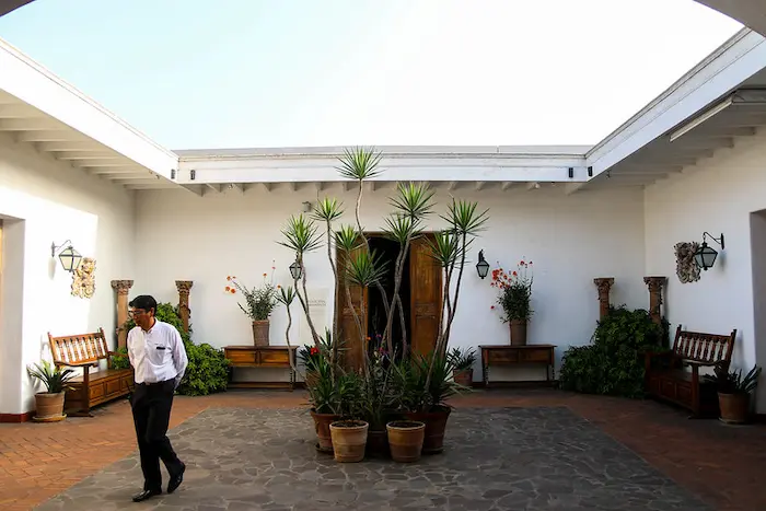 a man walking in a courtyard